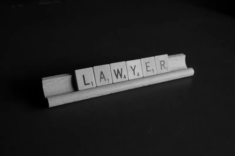 The word "lawyer" (barrister vs solicitor) spelled in Scrabble pieces